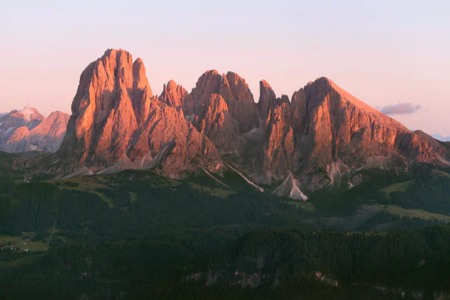 View of Sassolungo illuminated in red by the sunset