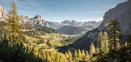 Panoramic view over the green fields and majestic mountains in the Alta Badia region during a sunny summer day