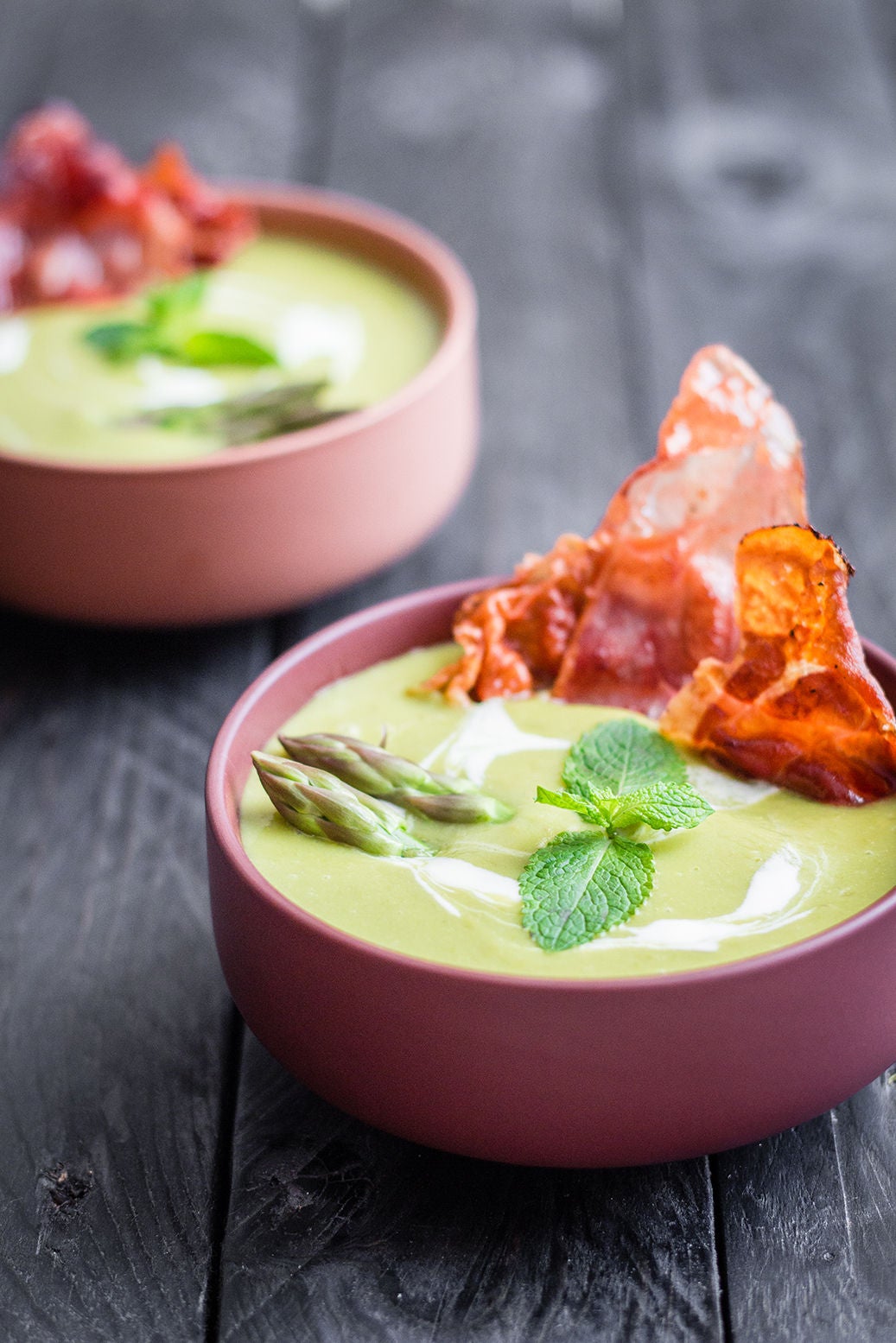 Zwei Schüsseln Erbsensuppe mit Spargelspitzen