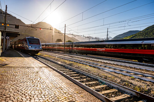 View from the platform of a stationary and passing train.