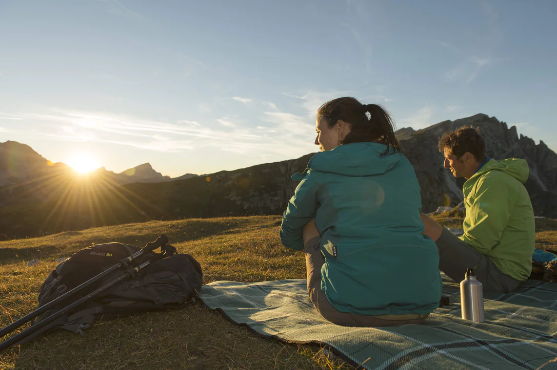 A woman and a man enjoying a hike around the Three Peaks
