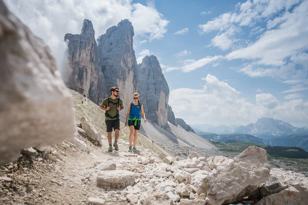 Ein Mann und eine Frau wandern durch die schroffen, felsigen Dolomiten