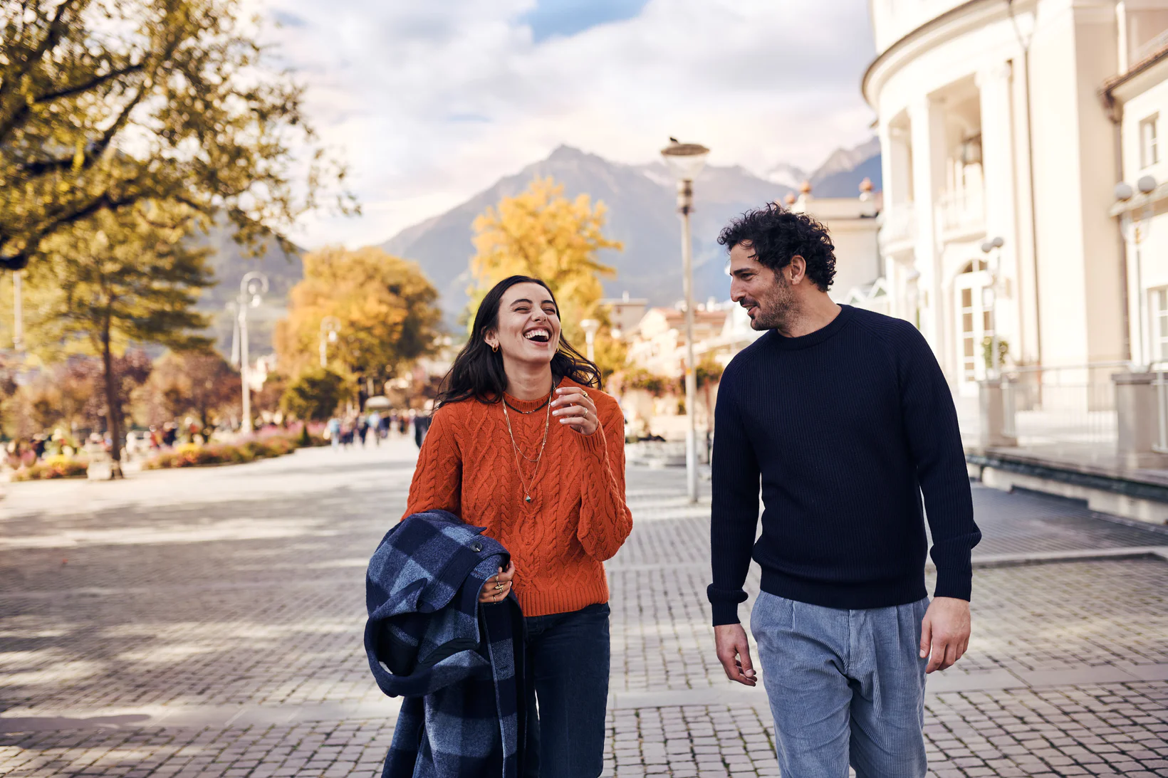 Two people weave their way through the town centre