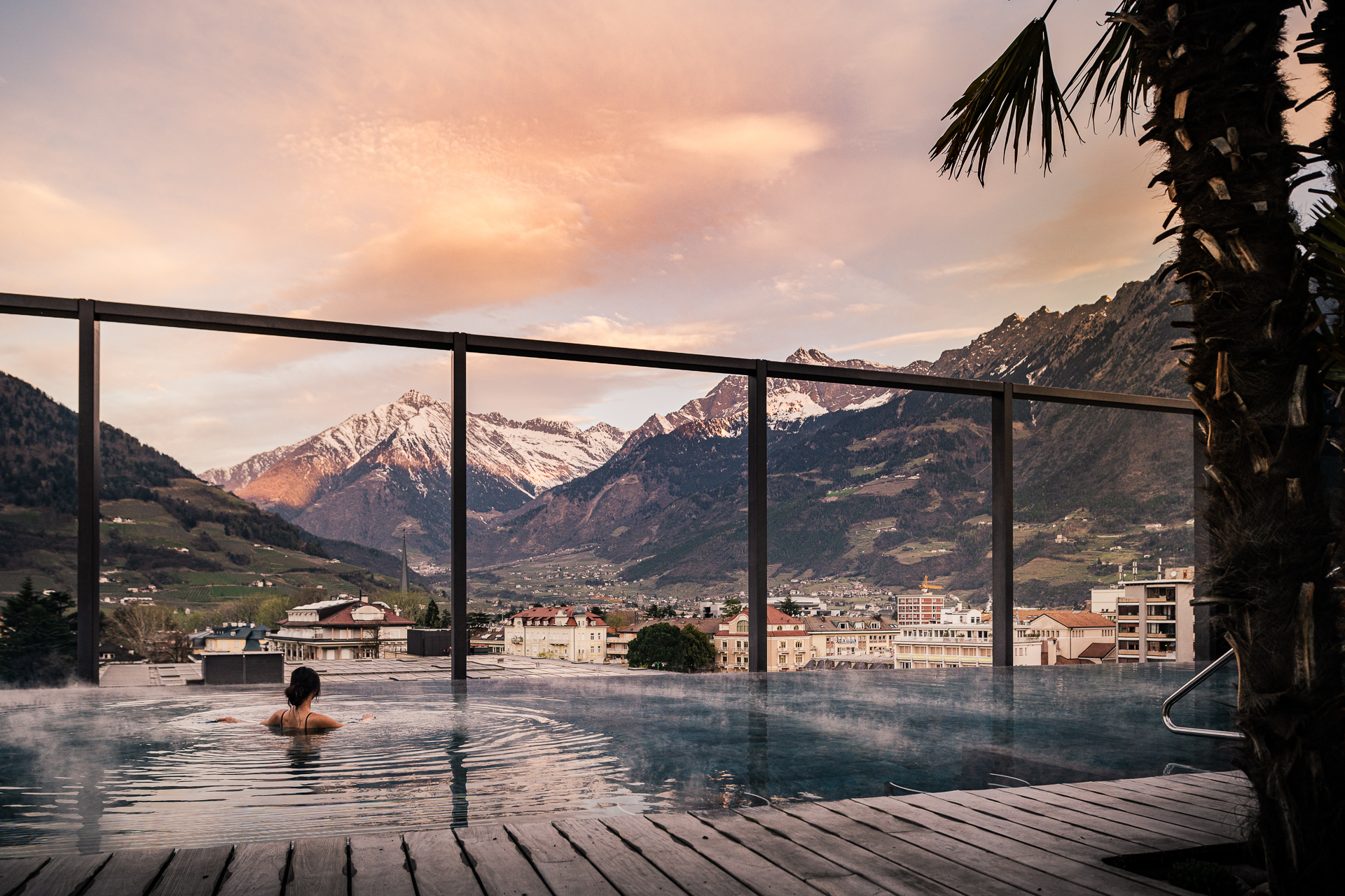 Personne profitant des thermes de Meran (vue sur une vallée, avec des montagnes en arrière-plan)