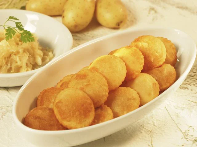 Deep-fried potato dumplings with sauerkraut