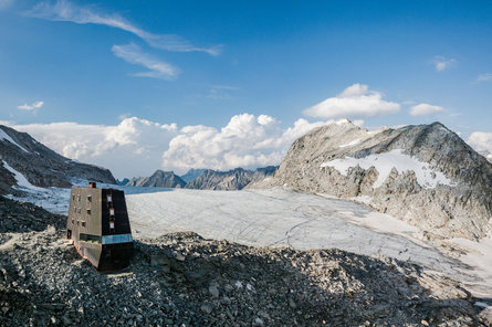 Chata Schwarzensteinhütte před ledovcem Schwarzensteinkees v údolí Ahrntal.