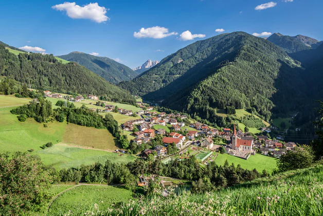 Panoramic view over Lüsen/Luson sorrounded by green forests and fields