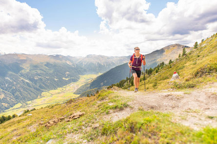 A woman walking up a mountain.