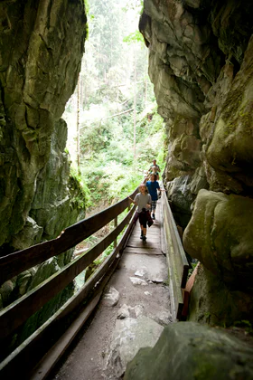 Several people walking through the mountains