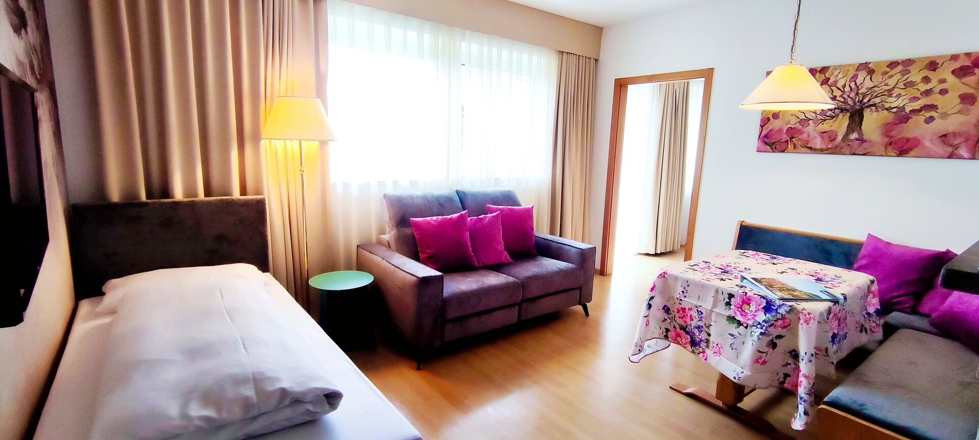 Living room with sitting area, with couch and extra bed for 3rd person