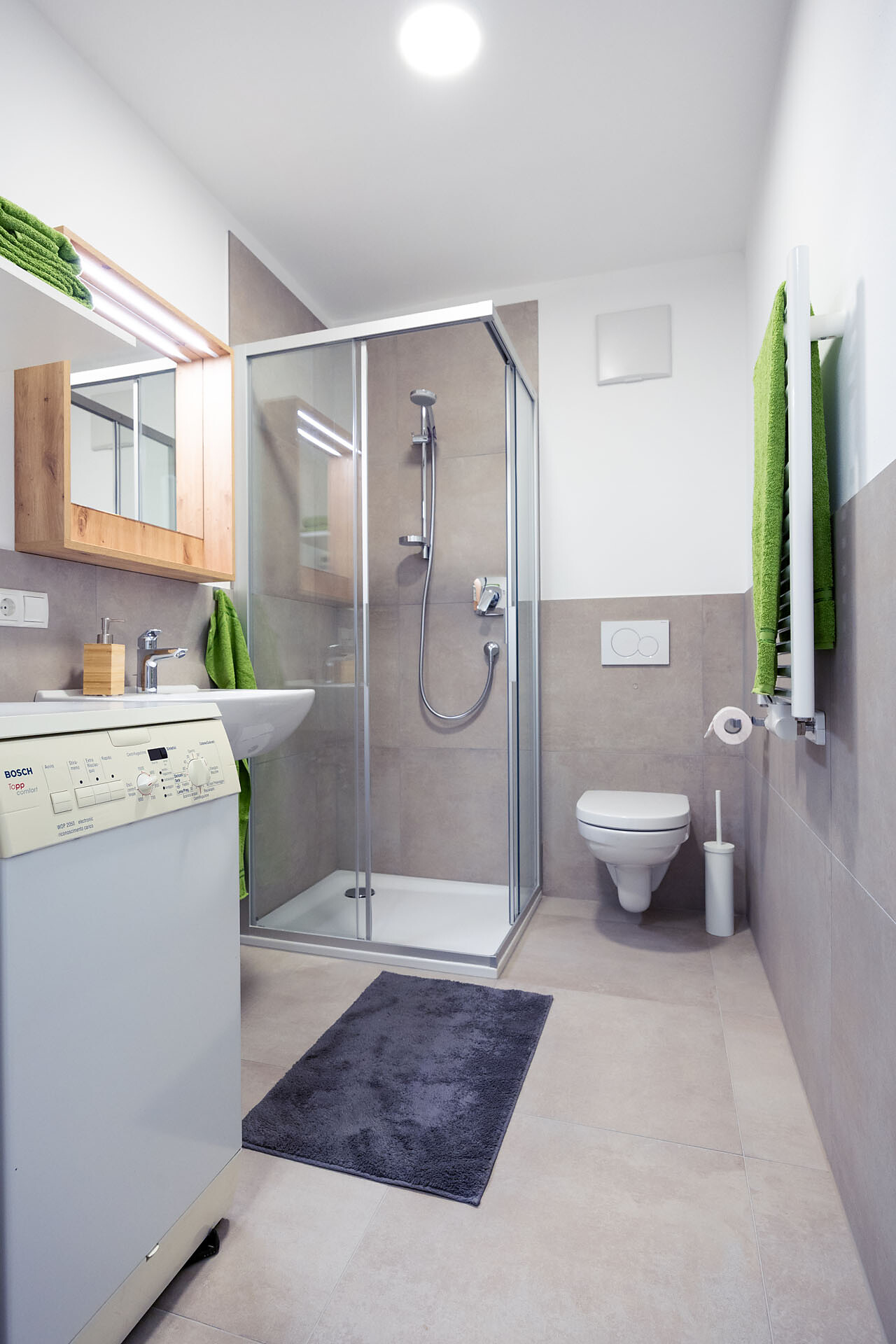 Bathroom with shower and washing machine
