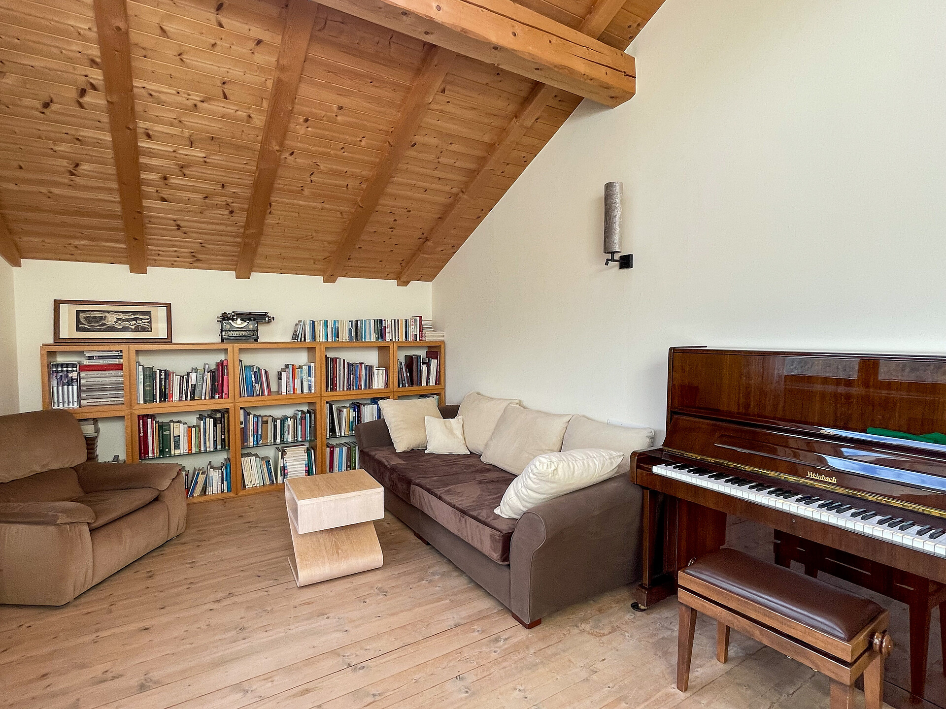 Livingroom with piano and library