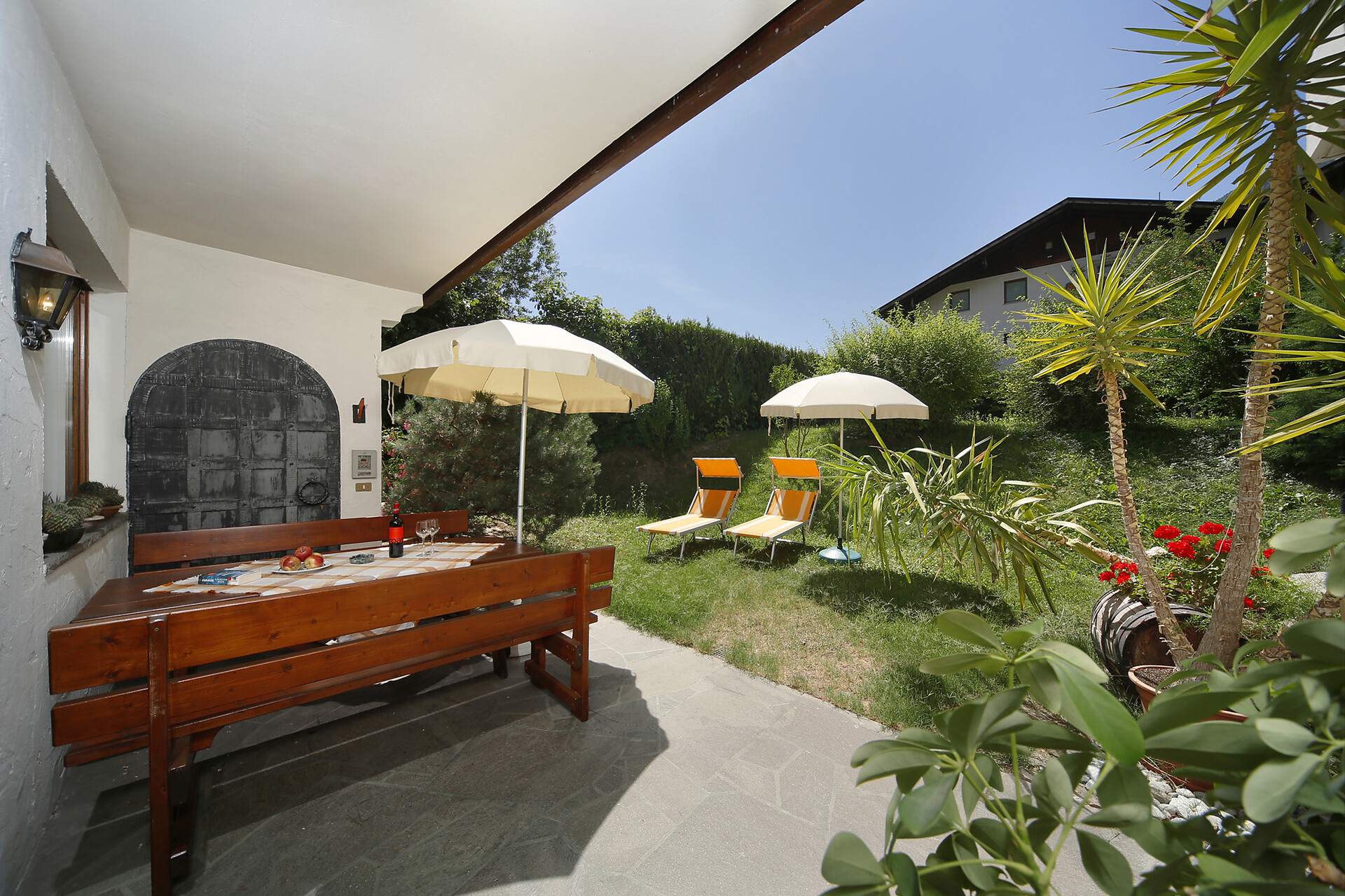Garden with sunbathing area and pleasant seating at Pension Haller