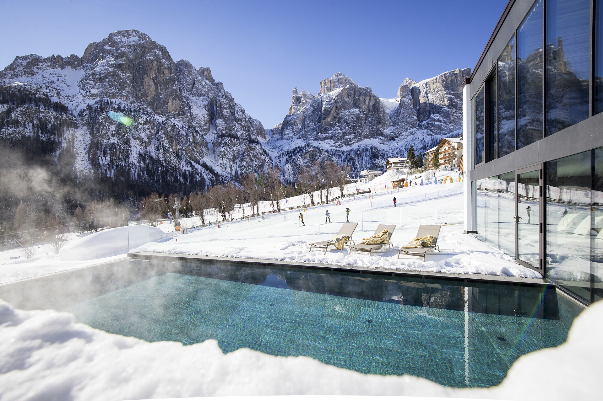 Outdoor swimming pool with panorama view to the Sella group