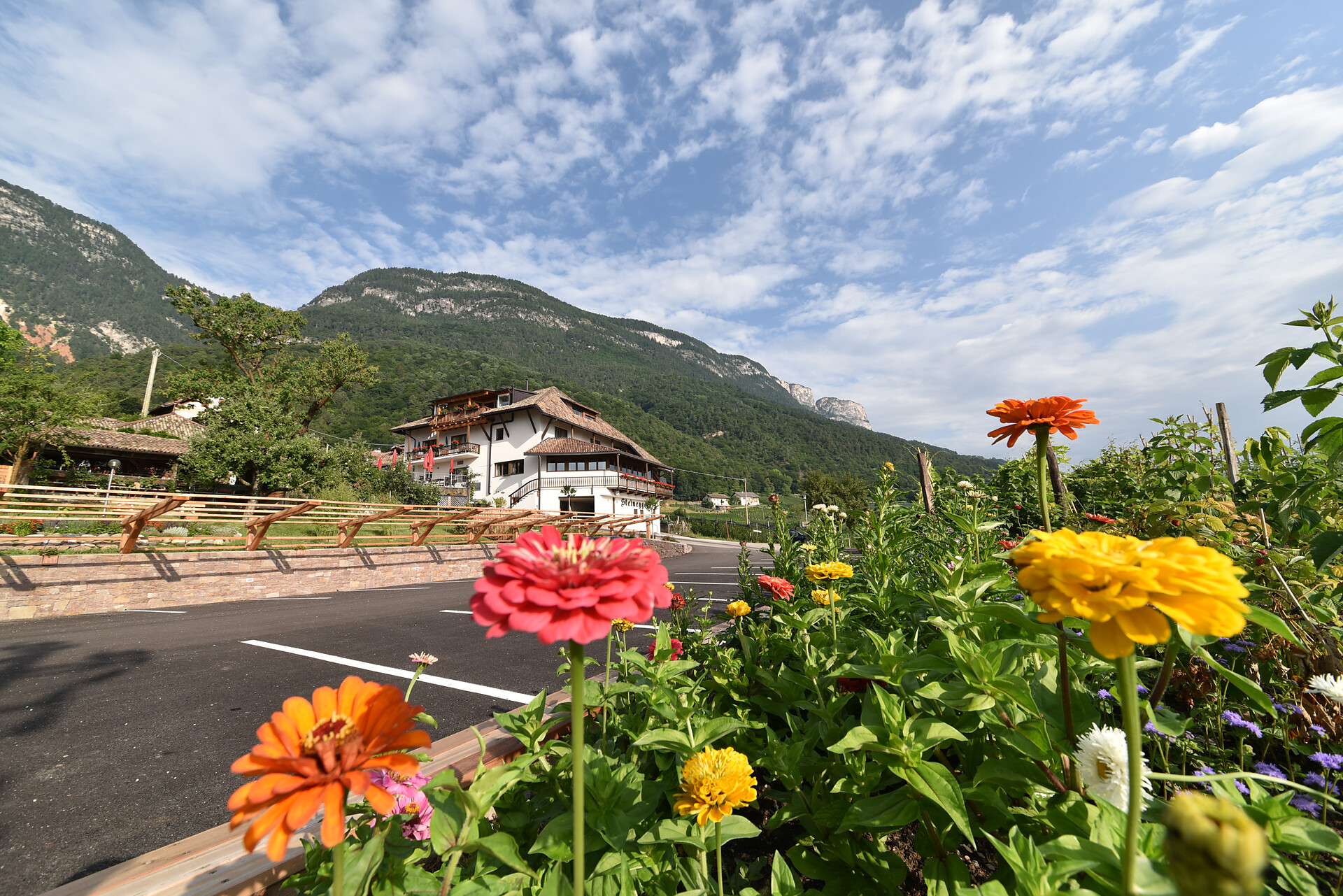 Parking with flowers and the mainhouse beyond