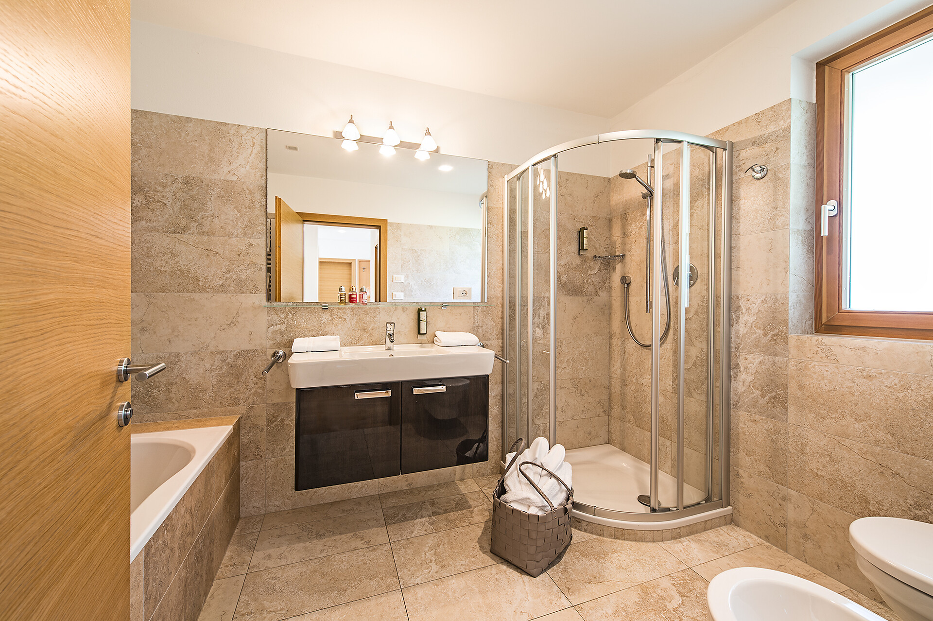 bathroom with tub, shower,  toilet, bidet