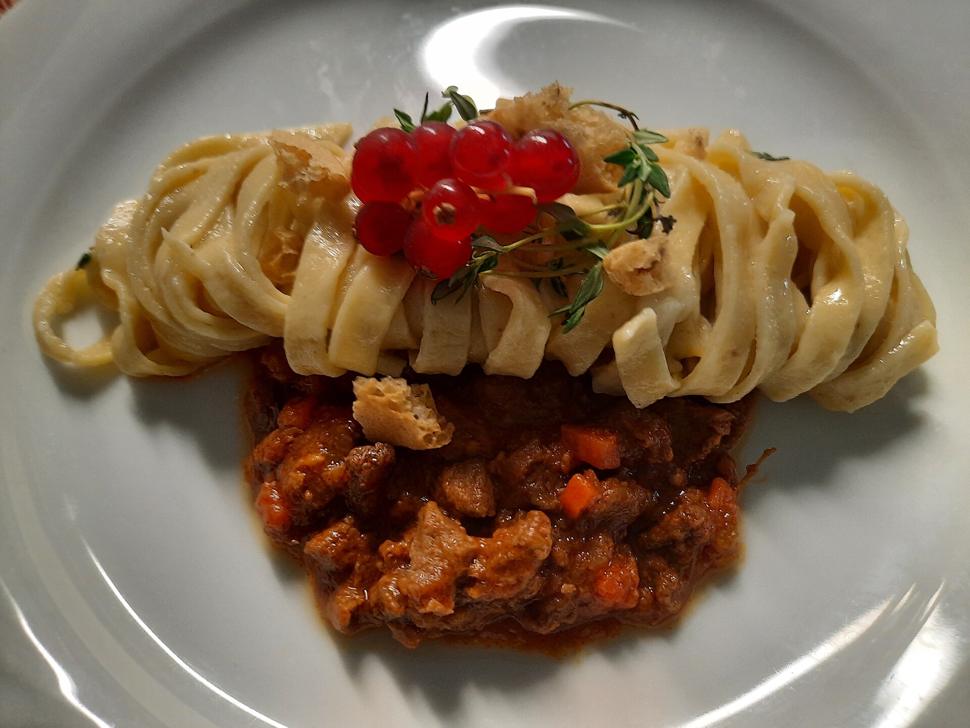 Home made black bread tagliatelle with deer ragout