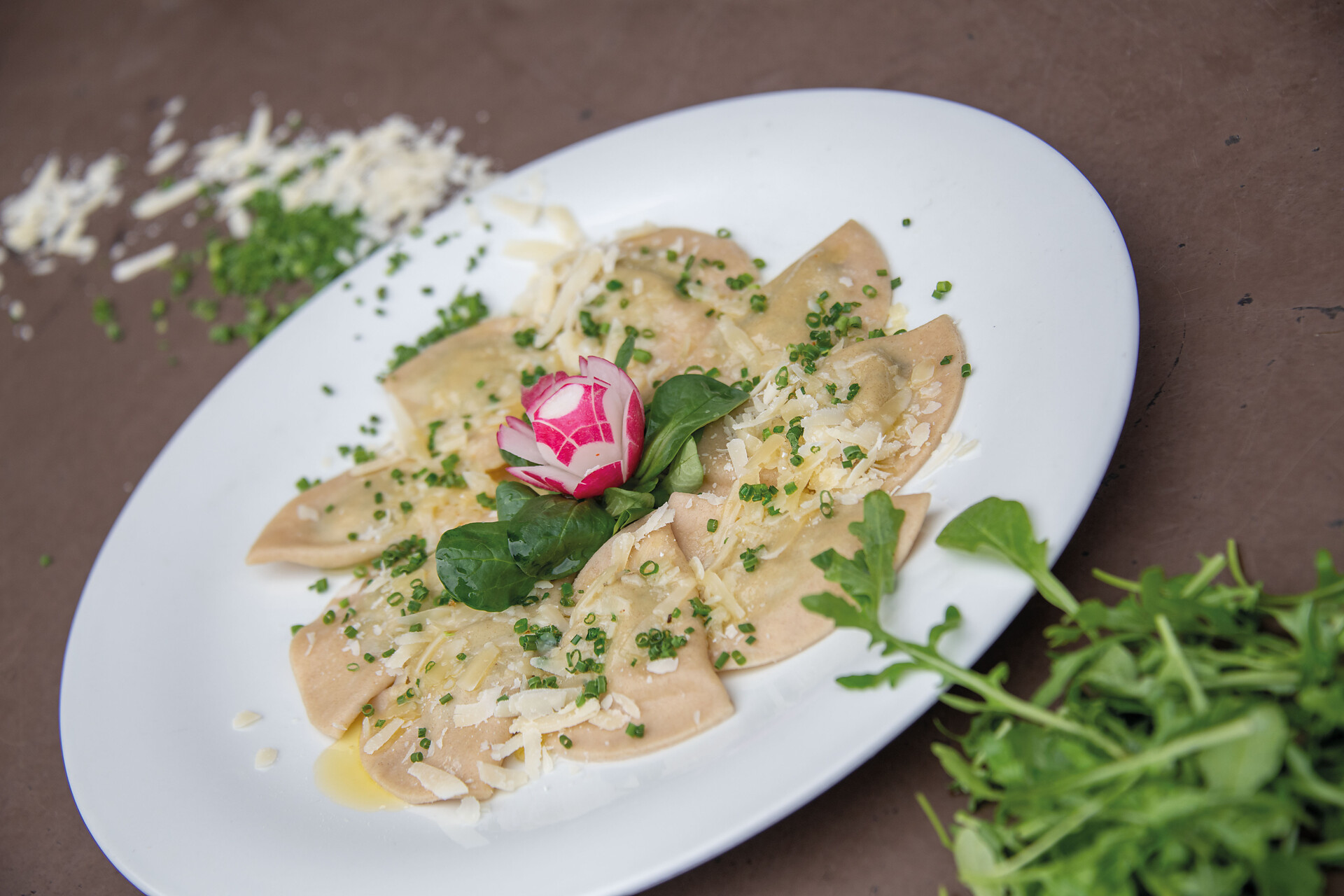 Homemade Schlutzkrapfen (Ravioli) with melted butter and parmesan