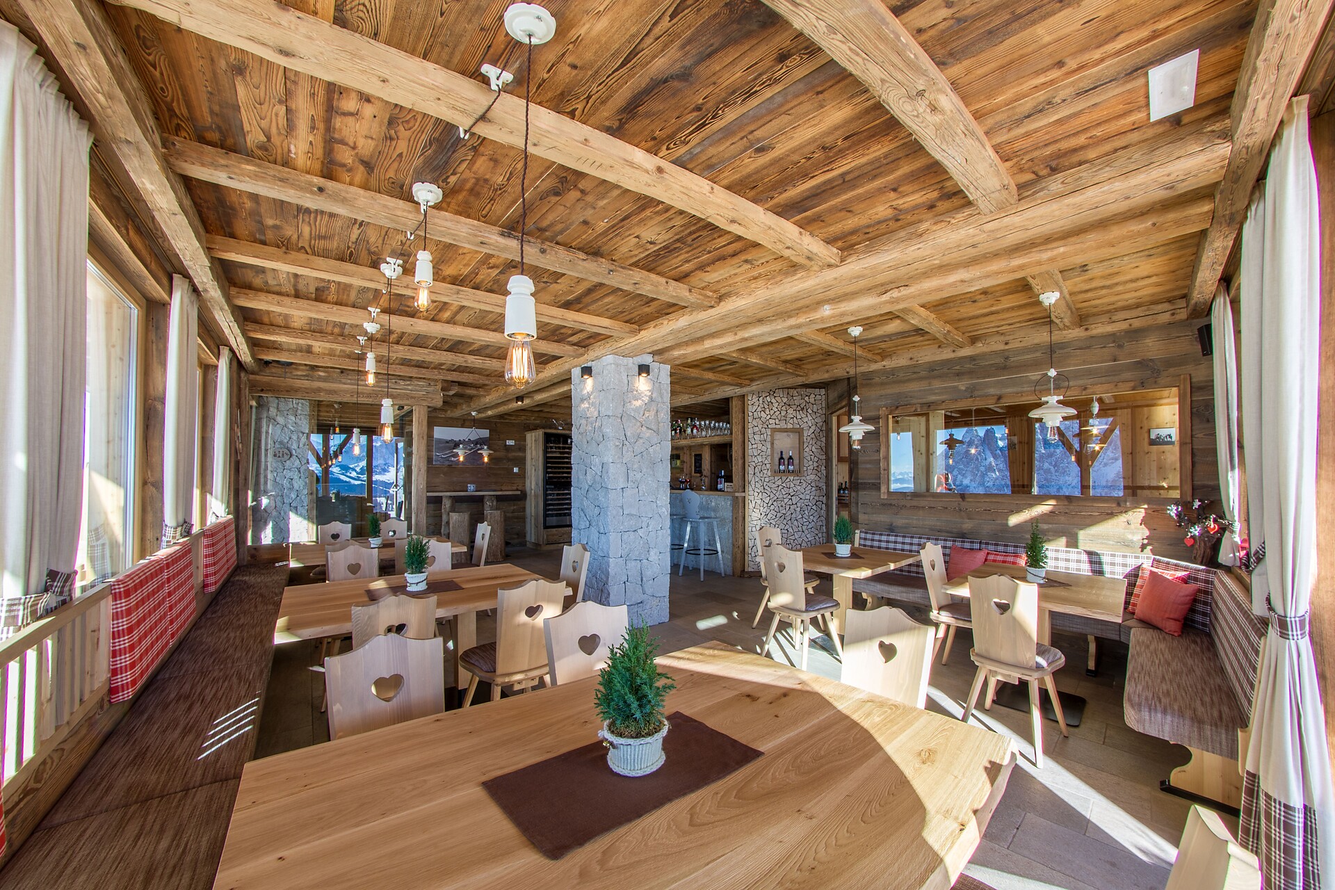 Panoramic: wood, glass and stones: art combination of products in the restaurant on Tschötsch Alm