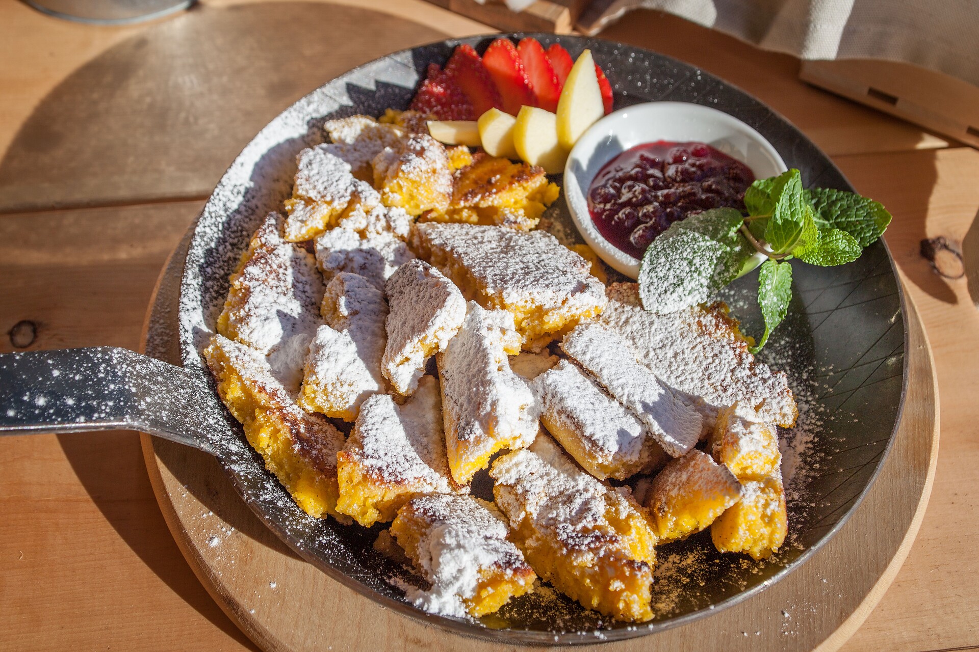 The most famous dish in the Alps: sliced pancake with cranberries on Tschötsch Alm mountain hut