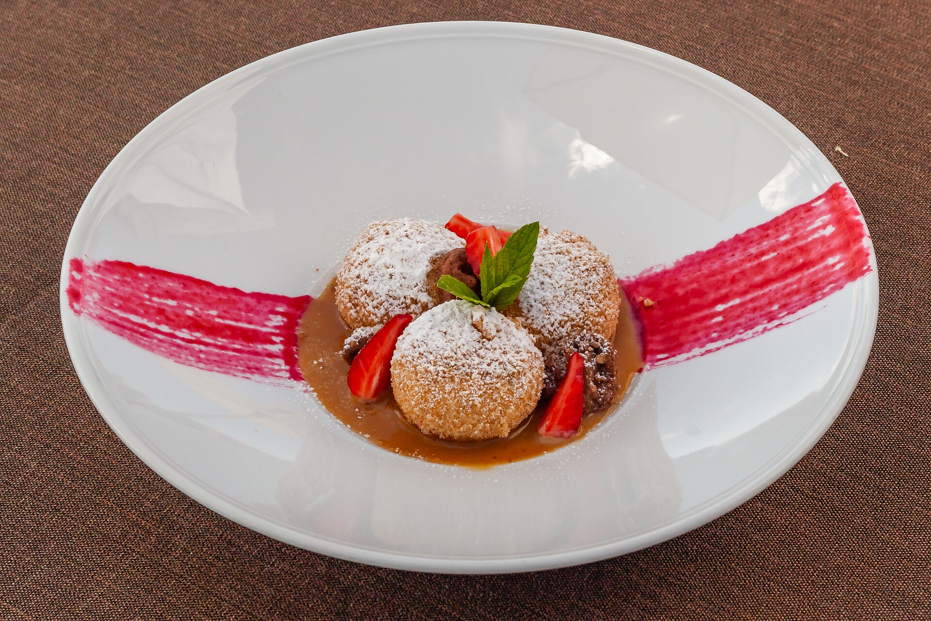 New creation: Sweet dumplings of cheese with nougat, caramel, chocolate crumble, raspberries