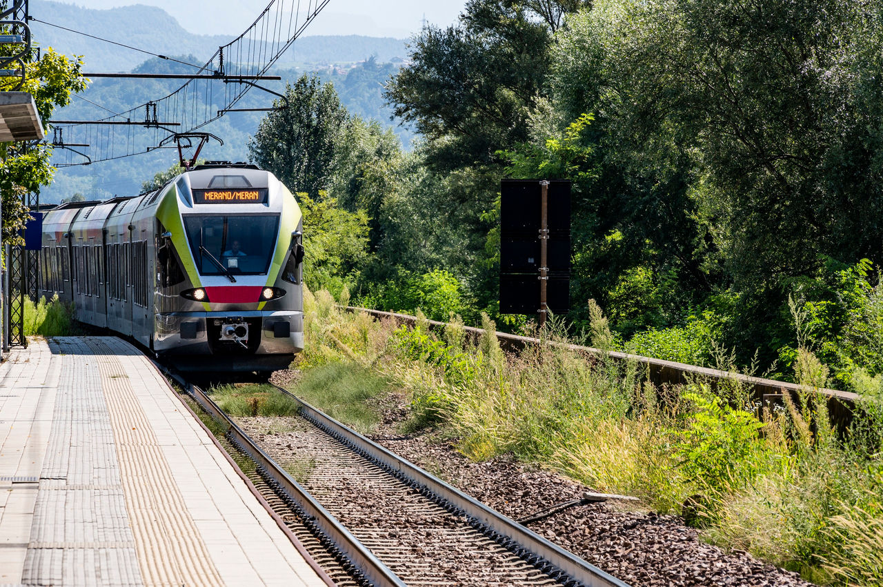 Ein Regionalzug der Vinschgerbahn mit Fahrtziel Meran fährt in einen Bahnhof ein.