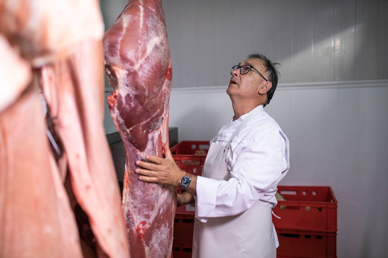 Metzger Alexander Holzner begutachtet das Fleisch eines geschlachteten Tiers.